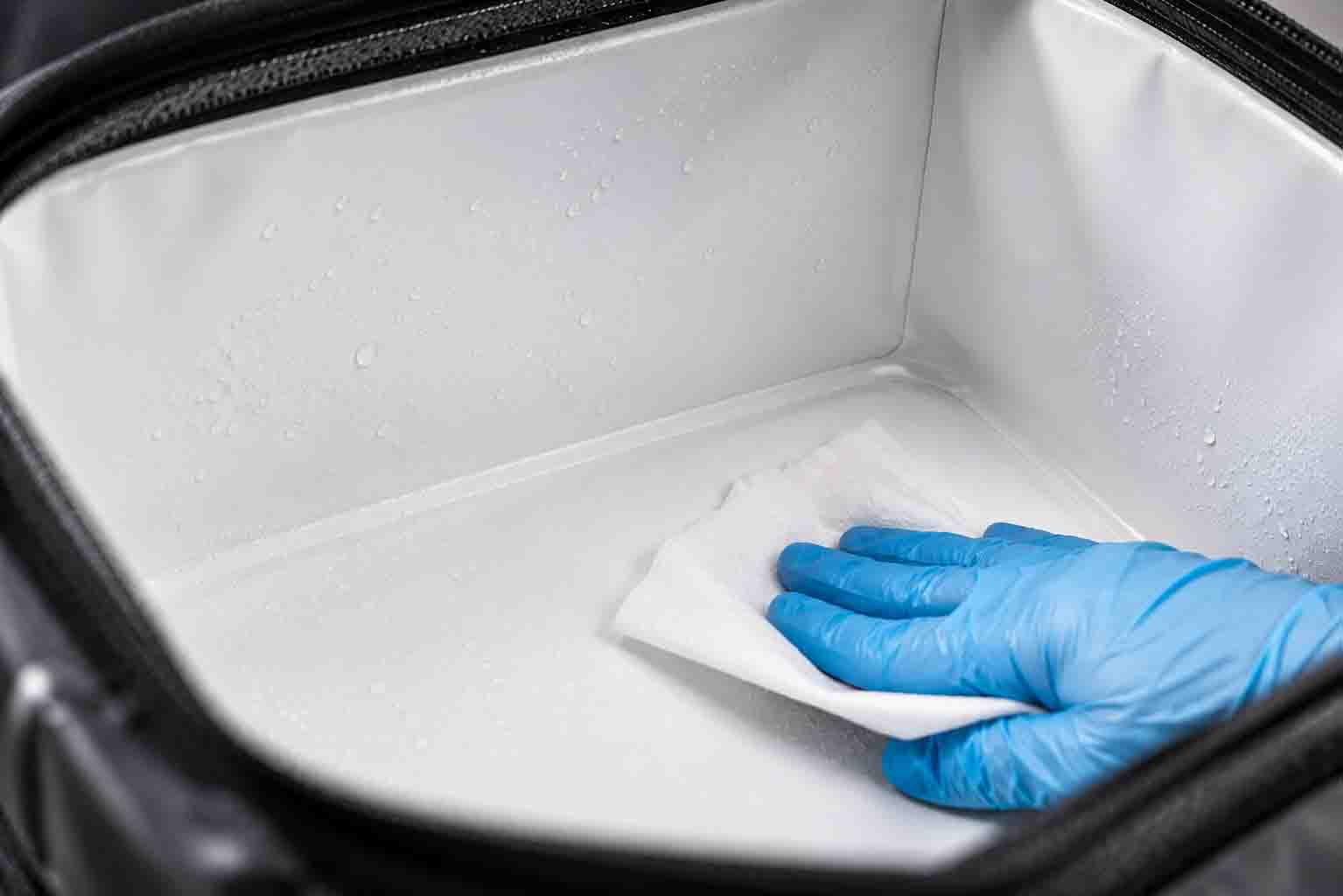 Seamless, RF-welded leak-proof interior of a commercial food delivery soft cooler, demonstrating easy sanitization.
